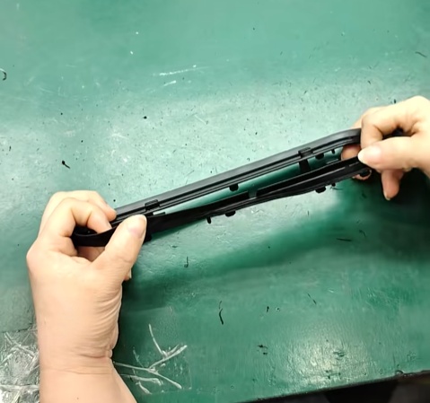 Two-shot molded rigid and soft material transition with recessed shutoff detail